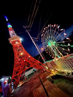 Outdoors at night,  Model versions of the Tokyo Tower and Tokyo Dome Ferris wheel, with the Tokyo tower maybe being about 5 meters tall