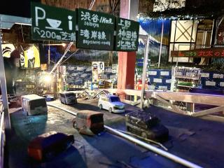 Model of the rainbow bridge in Tokyo with cars and shibuya in the background 