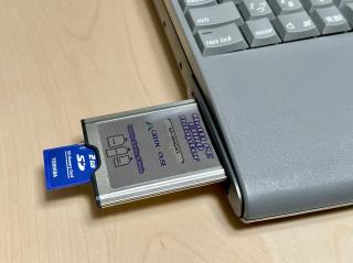 An SD card going into a PCMCIA card going into a PowerBook 540c
