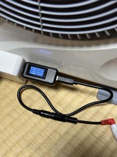 A USB-C power meter showing 8.5V 1.45 A / 12.4 W
