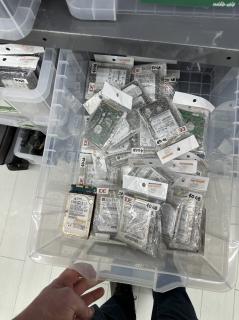 A plastic drawer full of IDE hard disks priced at 500 yen
