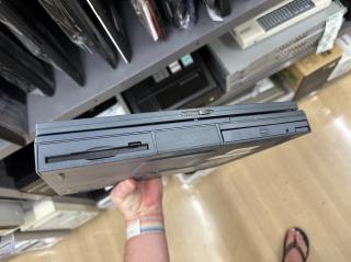 Front of laptop revealing floppy drive, battery bay and CD-ROM drive
