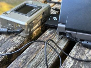 A 2.5mm jack plugged in between a digital camera and handheld pc