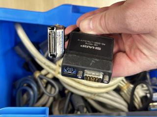 A black box with Mac & PC Serial ports, and a slimline connector with the textSHARPCE-150TSRS-232C レベルコンバー