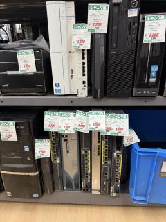 Two shelves with PCs and enterprise network switches