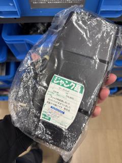 A plastic bag containing a large black plastic device.A green label says ジャンク品ワークパッドメーカー名PALMPALM3Cチェック時起動しましたタッチパッド生きていました。液晶やや暗いです。現状品