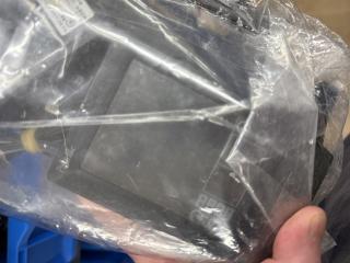 The plastic bag but a dark screened Palm is visible through it