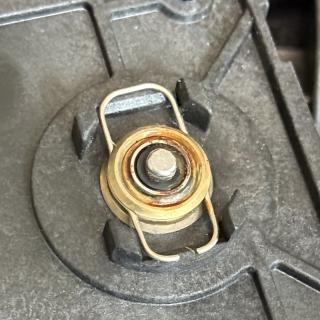 Bottom of a small motor, revealing rust