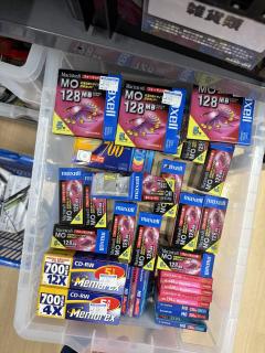 A plastic tub full of Mac preformatted Maxell MO discs