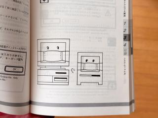 A desktop mac and a mac colour classic wearing face masks