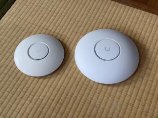 Two round white discs with U logos on them, one bigger than the other
