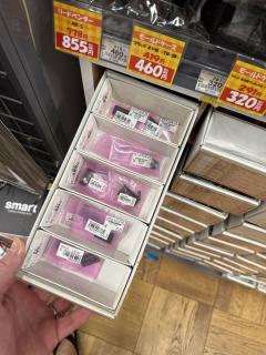 Hand holding a small box containing IC chips in small baggies
