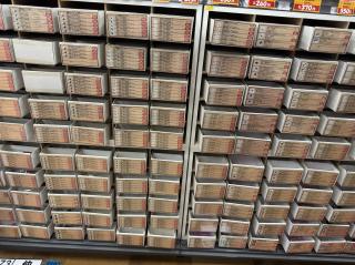 100+ small drawers labeled with electronics components like resistors, transistors, bridge rectifiers, zener diodes, etc