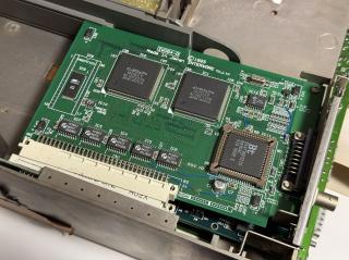 A closeup of a green circuit board. There are two prominent chips that say インタウェア and the board says Made in Japan INTERWARE co Ltd (c) 1993 TW064-A