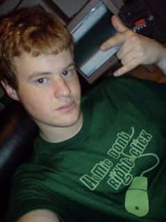 Some little kid wearing a T-Shirt that says “Homie don't right-click” with a graphic of an Apple Desktop Bus Mouse II