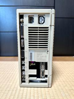 The rear of a Quadra 700, but the plastic around the row of ports and NuBus slots has been crudely hacked off and the ports don't line up