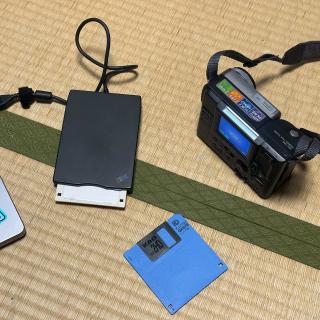 The camera, a floppy and a black, IBM-branded USB floppy drive.