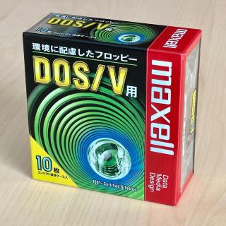 Box of floppy disks marked maxell DOS/Vç”¨ with 90's design pattern of green circles emanating from a blue circle with an eye in it