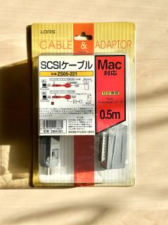 A box for a SCSI cable with text in Japanese on it.The diagram on the box shows that it can be used to connect both a Zip drive and an external hard disk at the same time.