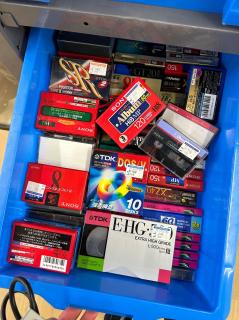 A blue bin full of tapes - Video8, Hi8, SVHS-C, audio cassette (type I and II), floppies, beta