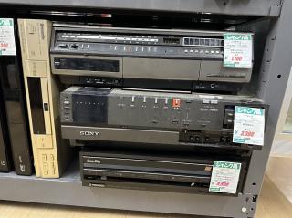 Closeup of a stack of VHS, Beta and Laserdisc players