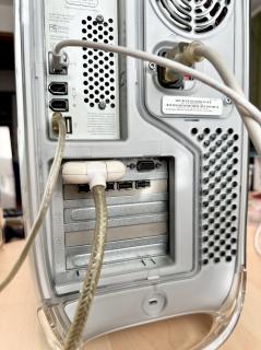 The rear of a PowerMac G4 with the plug inserted 