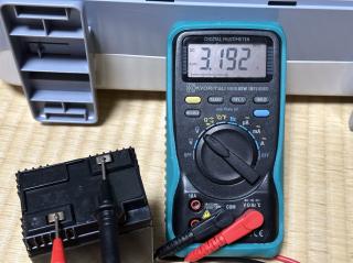 A multimeter measuring a 6V SLA battery and showing 3.2V
