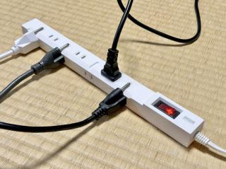 A power strip, with indents on the outside plastic to fit a grounding prong so you can plug in grounded plugs into the ungrounded power strip