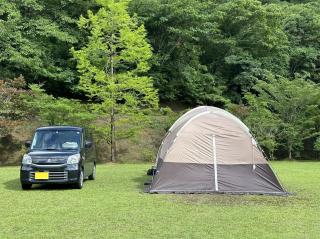 A kei car and our family tent. The tent is bigger than the car and could serve as the garage.