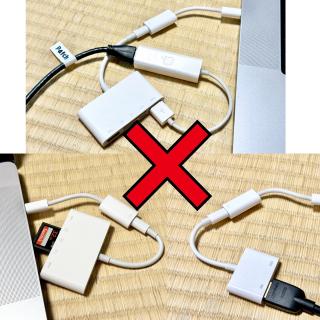 A MacBook connected to an adapter connected to an adapter connected to a USB Ethernet deviceA MacBook connected to an adapter connected to an adapter with a SD card inside itA MacBook connected to an adapter connected to an adapter connected to an HDMI cable