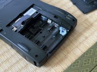 The battery compartment of a Newton MessagePad 130, revealing a big battery leak