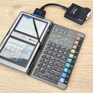 A Sharp PA-9500 personal digital organizer with a science card inserted and a CE-150TS connected