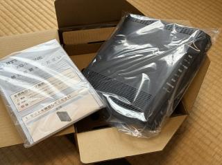 Inside of the box. A manual and a boxy square router.