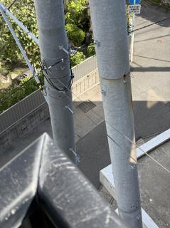 Two black wires off an aluminum telephone pole