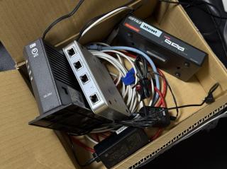 A box with 1 Gbit networking equipment, a fiber ONU, a Ubiquiti USG3, and a 5 port switch