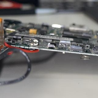 Side angle shot of a Newton PCB with a chip that is not flat on the board