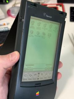A Newton MP130 held at an angle so you can see the indiglo green backlight