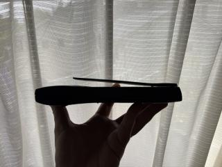 Silhouette of a Newton MessagePad. The screen protective plastic flap is bending upwards so it doesn't latch closed