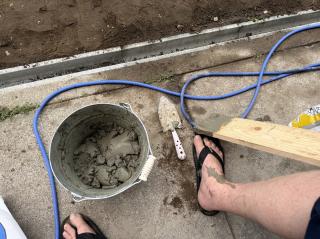 Trowel and concrete in a bucket