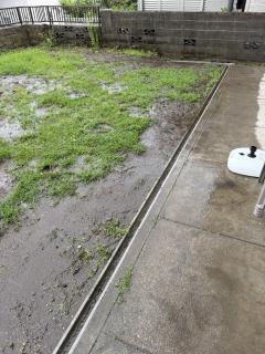 A yard with a drainage ditch and no pooling of water
