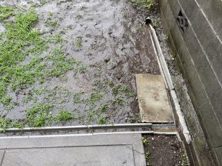 Closeup of the T-shape in the drainage ditch and you can see water flowing