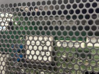 A closeup of a grille on the machine revealing what appears to be a Compact Flash card with the JASRAC logo on it