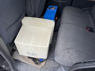 A chonk CRT in the rear row of a car