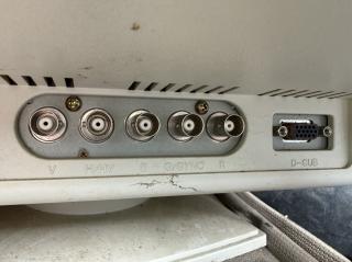 The rear inputs of a CRT, showing BNC ports marked V, H/HV, B, G/SYNC, R and a VGA port marked “D-SUB”