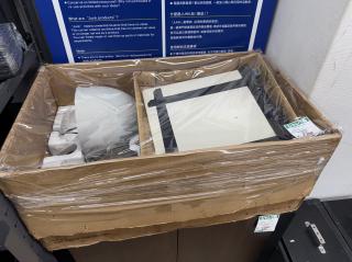 A big box that says FUJI PHOTO FILM ENLARGER S69 containing a big white plate and a big round thing