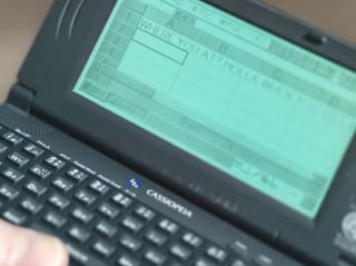 A Casio Cassiopeia with Microsoft Pocket Excel open with the text “WHERE YOU AT? HOLLA WHEN YOU GET H” written in cell A1